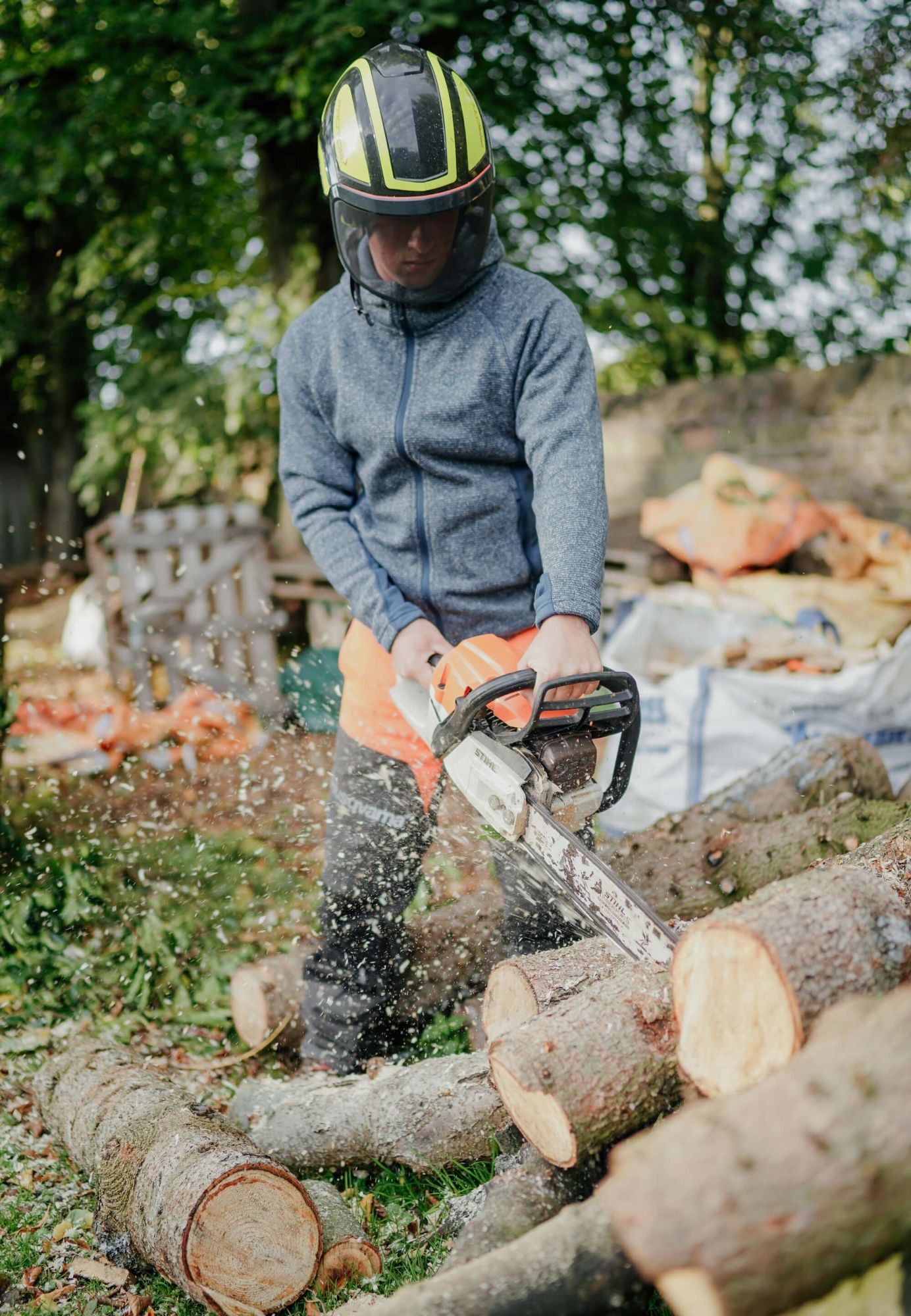 An Arborist processing wood to turn into logs for sale